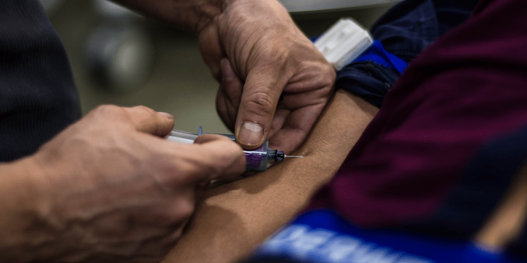 vaccine getting injected into arm